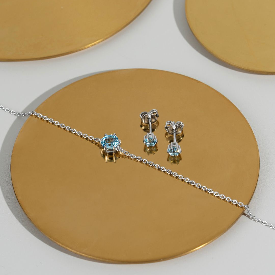 Juego clásico de aretes y pulsera con topacio azul redondo en plata de ley 925