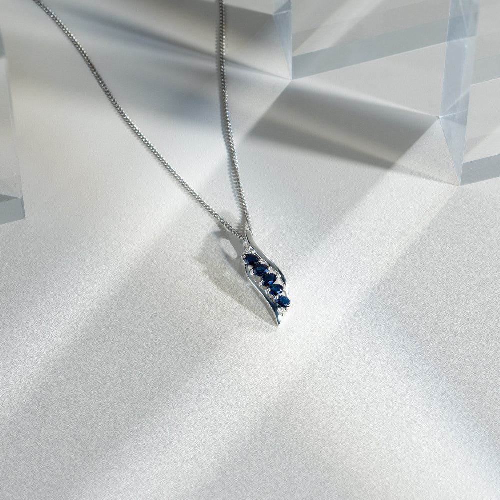 Modern Oval Sapphire & Diamond Leaf Pendant in 925 Sterling Silver flatlay