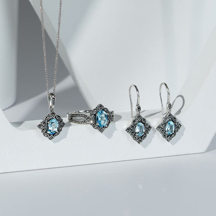 Pendientes colgantes de topacio azul ovalado y marcasita estilo Art Déco en plata de ley